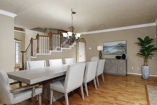 a view of a dining room with furniture and a chandelier