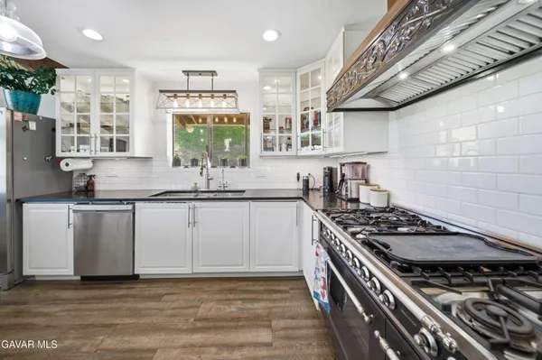 a kitchen with granite countertop a stove and a sink