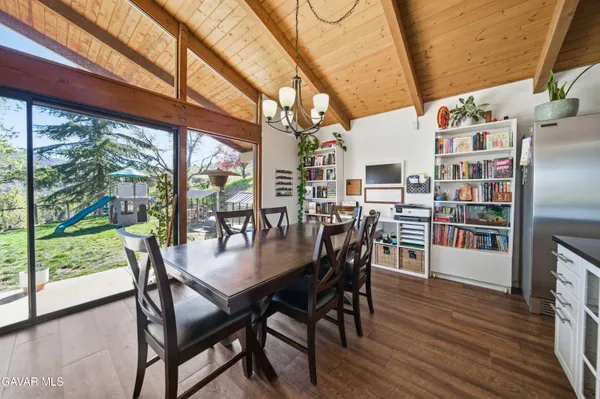 a dining room with furniture and wooden floor