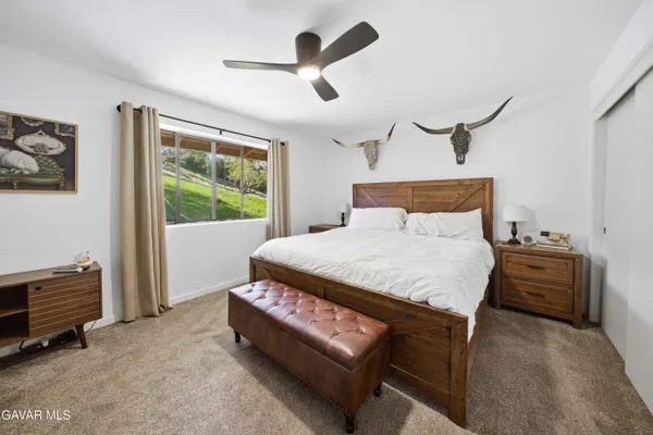 a bed sitting in a room next to a window
