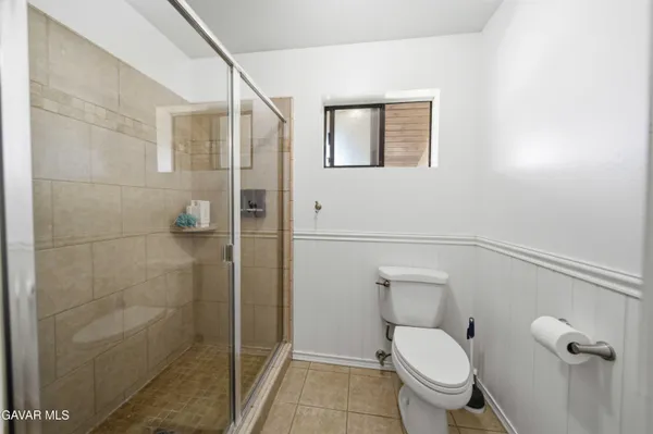a white toilet sitting next to a bathroom sink