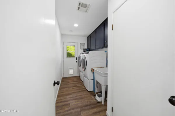 a hallway with a washer and dryer
