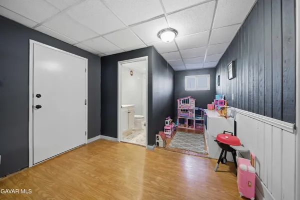 a view of a play room with wooden floor and stairs