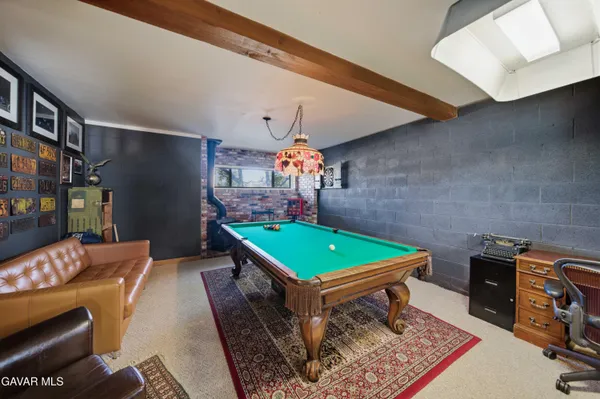 a room with pool table and windows