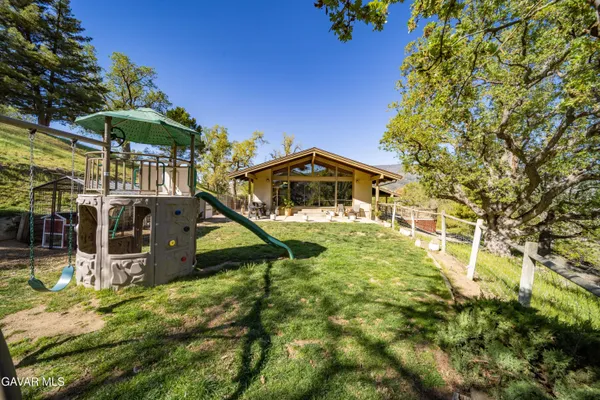 a view of house with backyard and patio