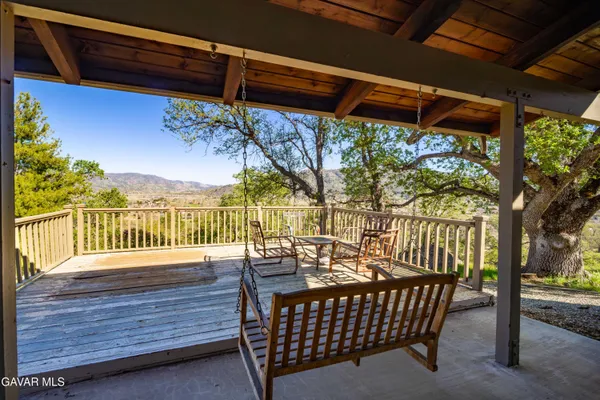a view of a wooden chairs on the deck