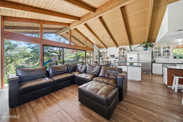 a living room with furniture and a floor to ceiling window