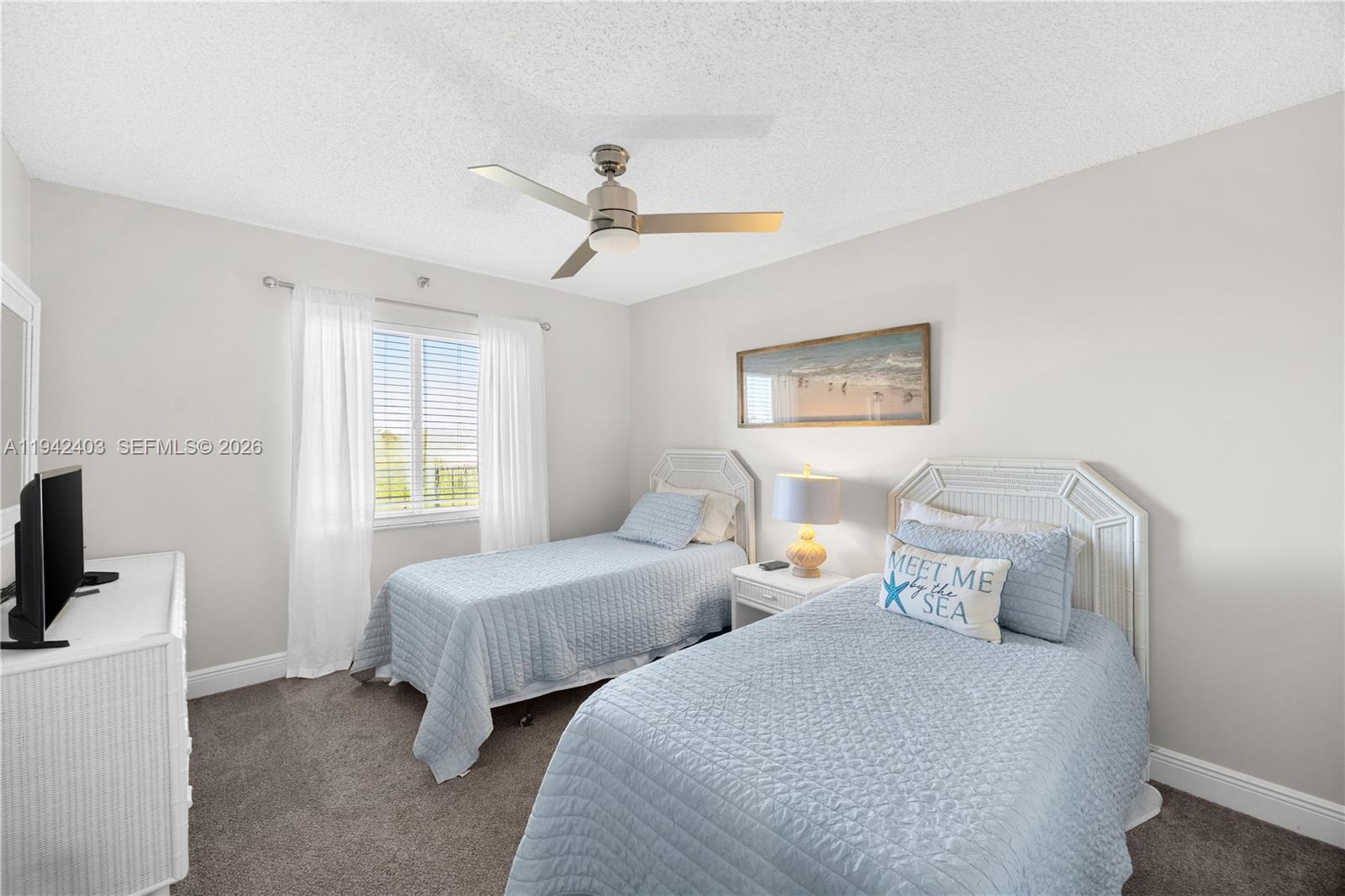 275 Palm Avenue, Unit A407 Jupiter, FL 33477 - Photo 19 of 29 a bedroom with two beds and a window