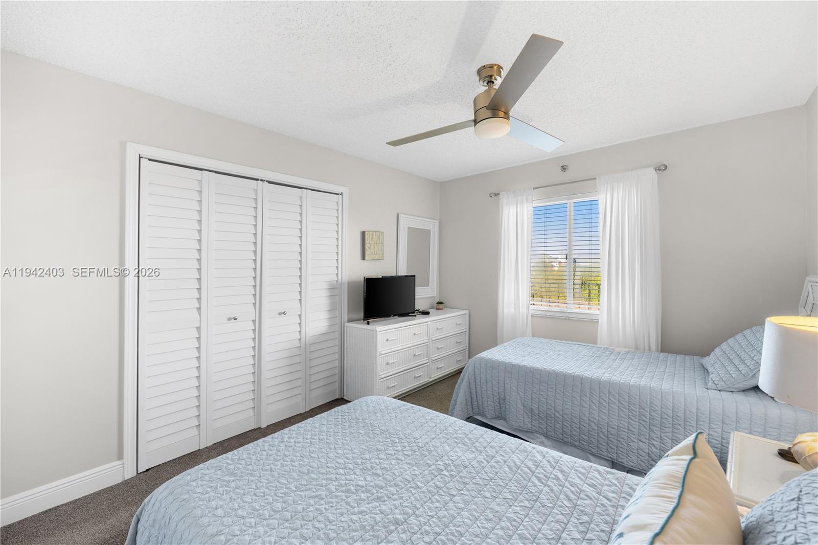 275 Palm Avenue, Unit A407 Jupiter, FL 33477 - Photo 20 of 29 a bedroom with furniture and a window