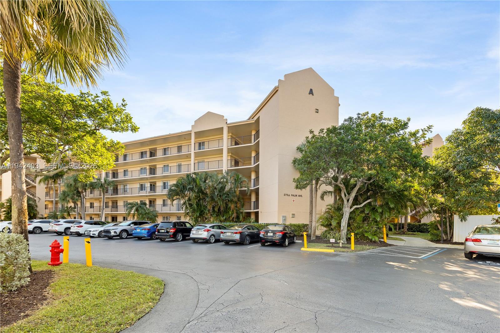 275 Palm Avenue, Unit A407 Jupiter, FL 33477 - Photo 23 of 29 a building with trees in front of it