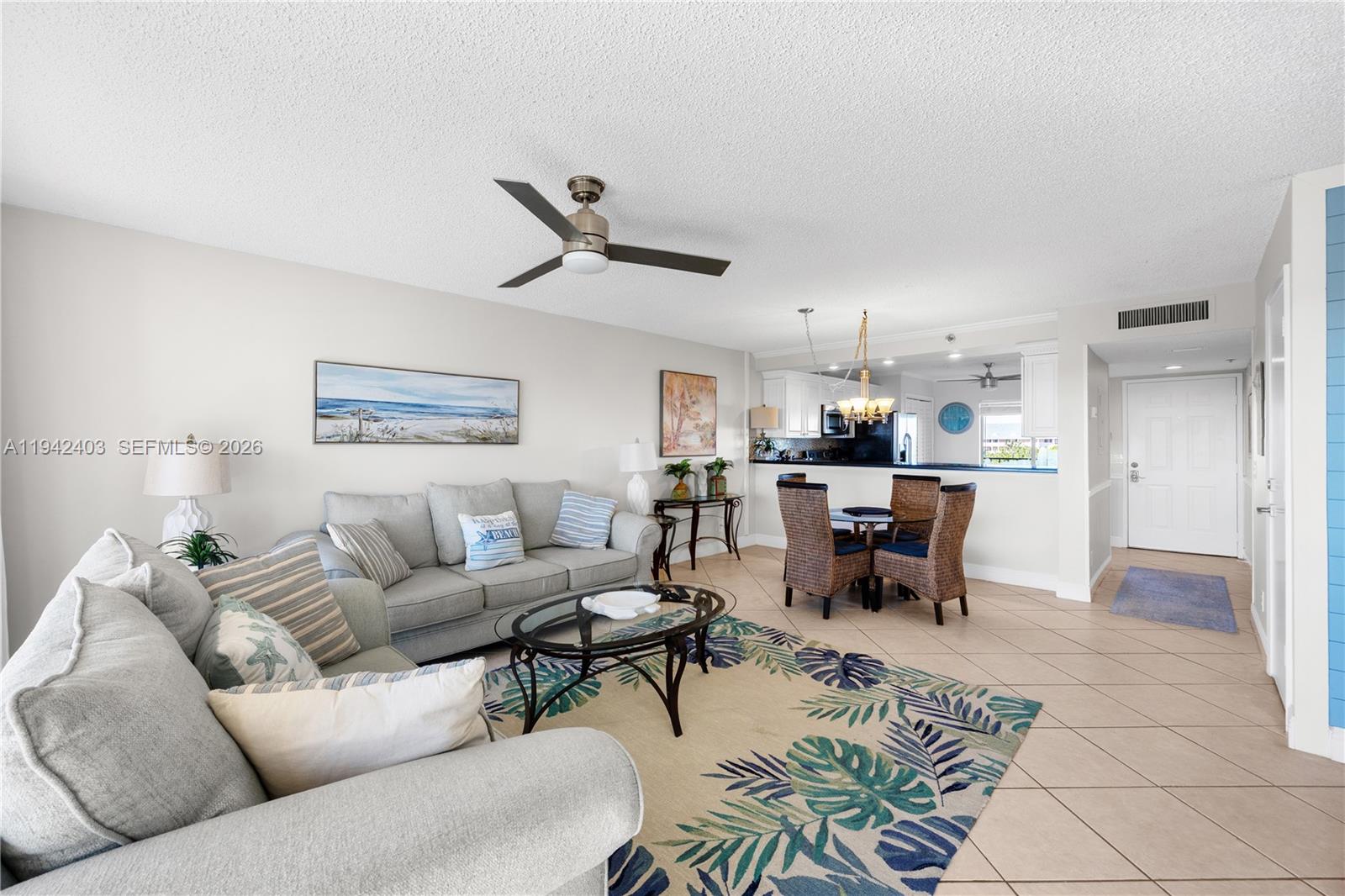 275 Palm Avenue, Unit A407 Jupiter, FL 33477 - Photo 3 of 29 a living room with furniture and kitchen view