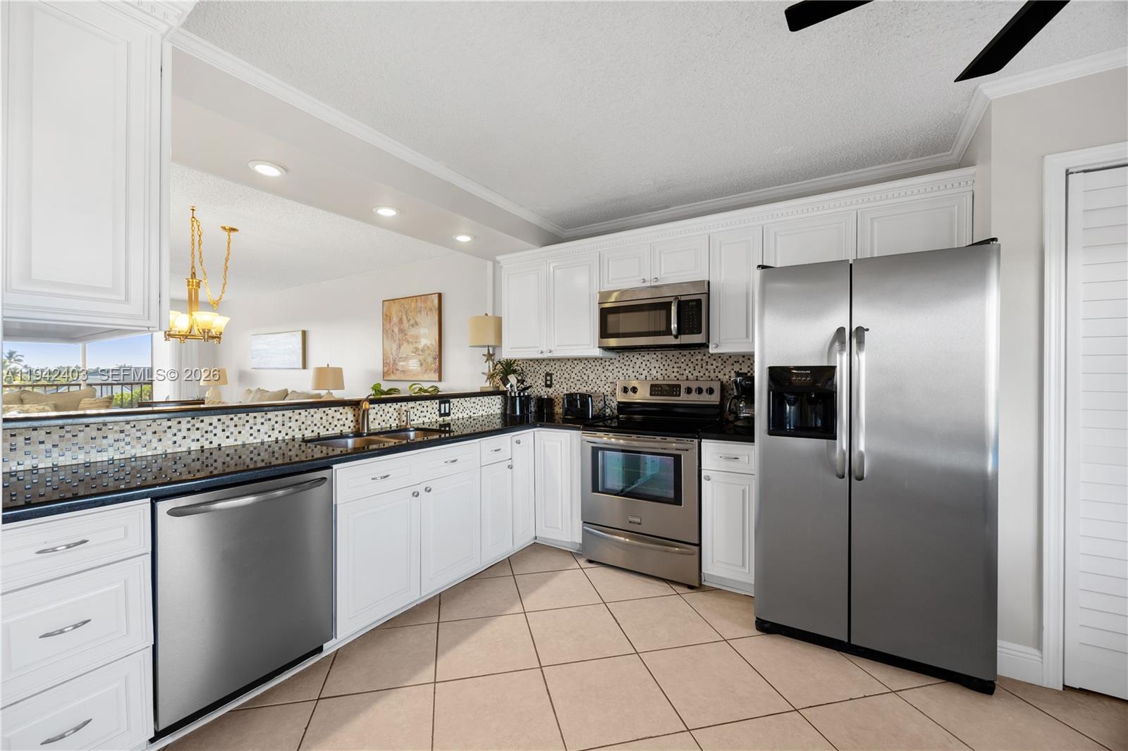 275 Palm Avenue, Unit A407 Jupiter, FL 33477 - Photo 8 of 29 a kitchen with granite countertop a cabinets and steel stainless steel appliances