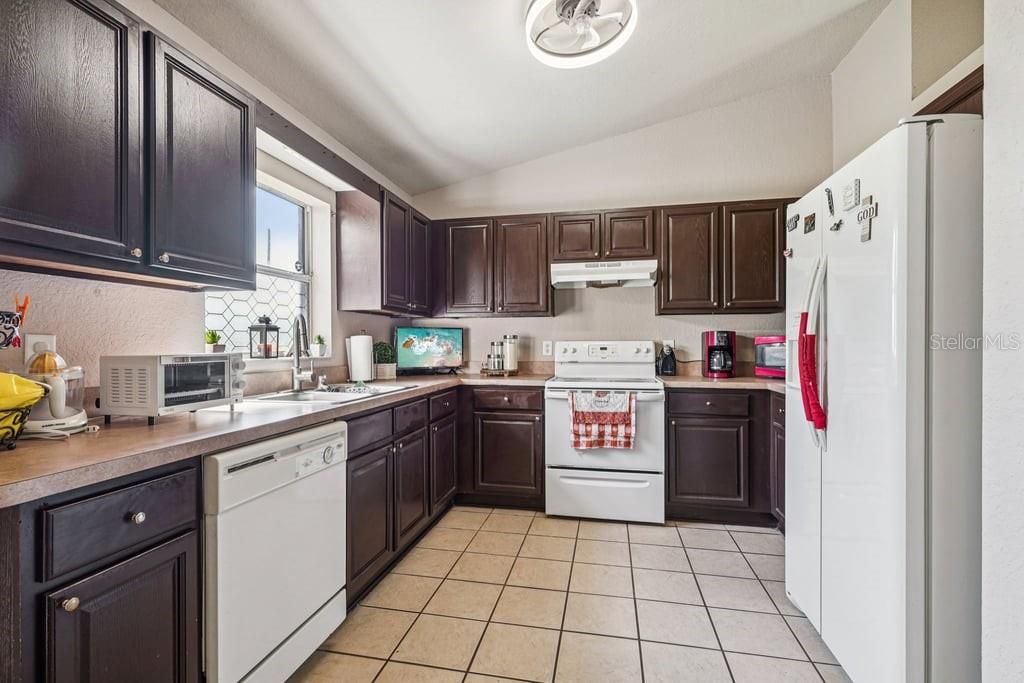 133 Walnut Road Ocala, FL 34480 - Photo 13 of 31 a kitchen with granite countertop a refrigerator stove top oven and sink