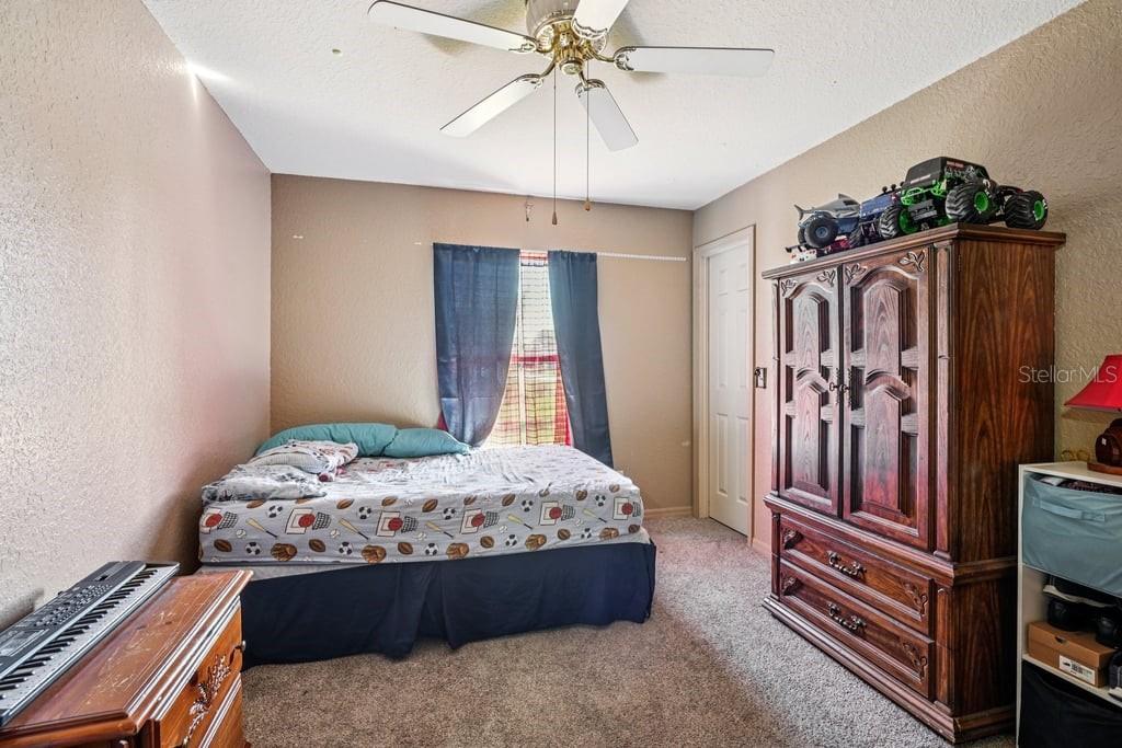 133 Walnut Road Ocala, FL 34480 - Photo 17 of 31 a bedroom with a bed and a chandelier