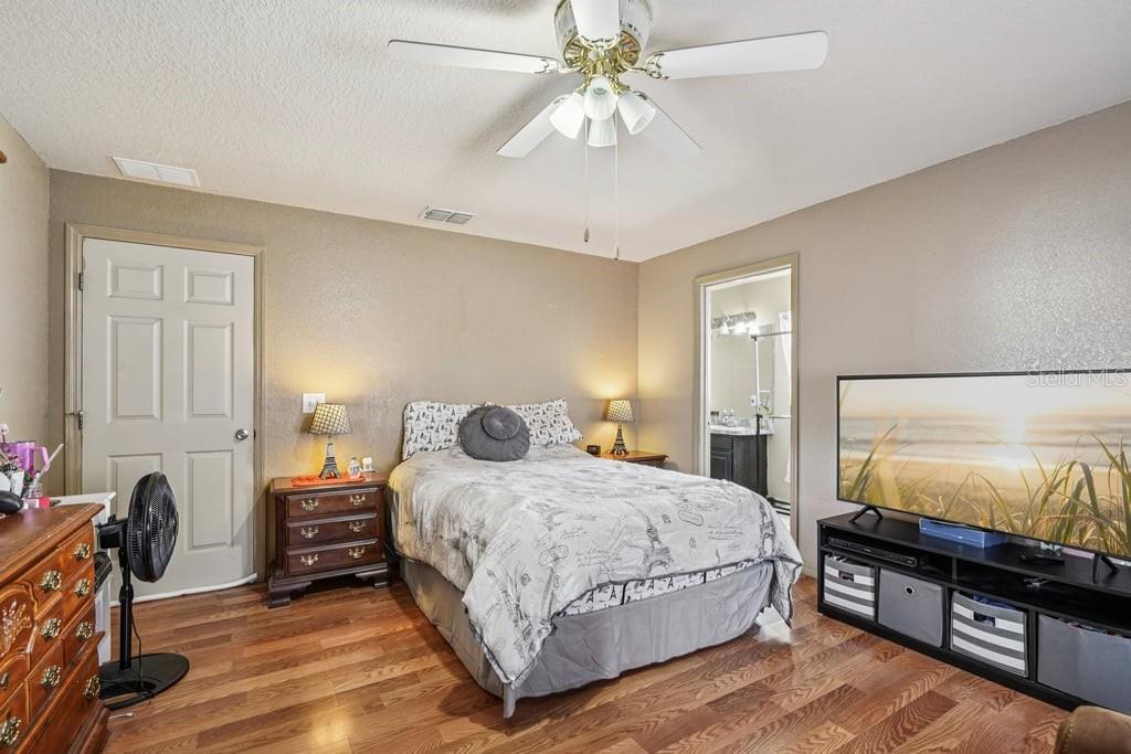 133 Walnut Road Ocala, FL 34480 - Photo 20 of 31 a bedroom with a bed and a flat tv screen on dresser