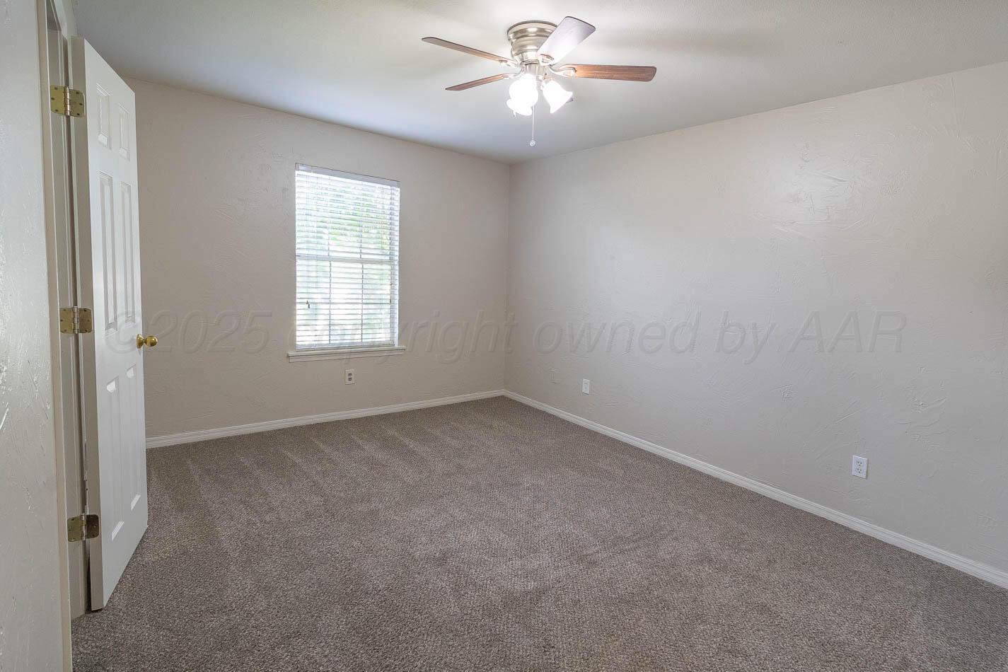7209 Dukes Place Amarillo, TX 79109 - Photo 11 of 20 an empty room with a window and a fan