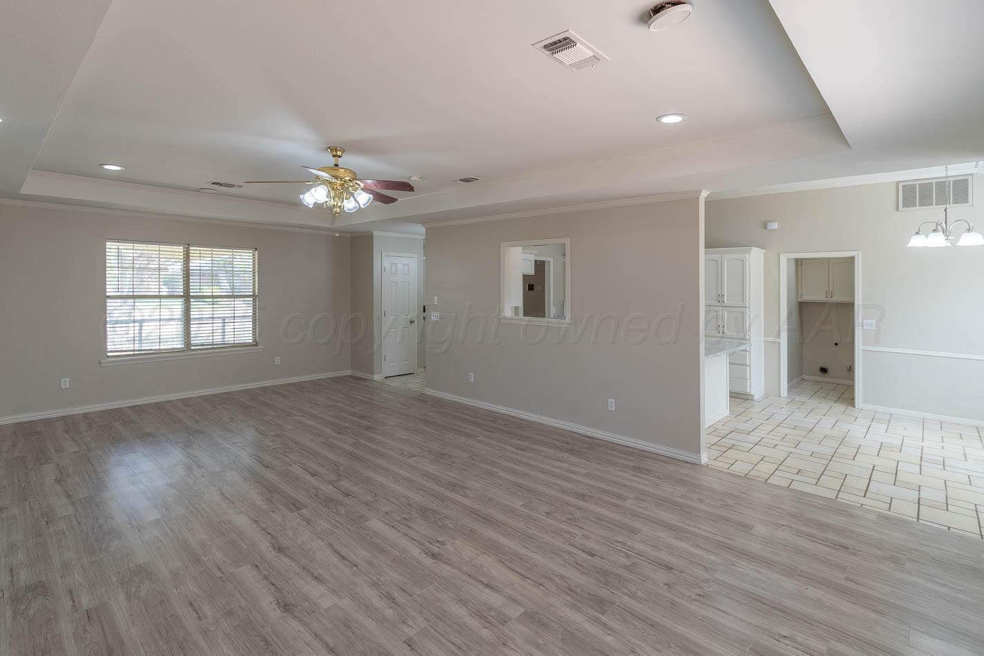 7209 Dukes Place Amarillo, TX 79109 - Photo 4 of 20 wooden floor in an empty room with a window