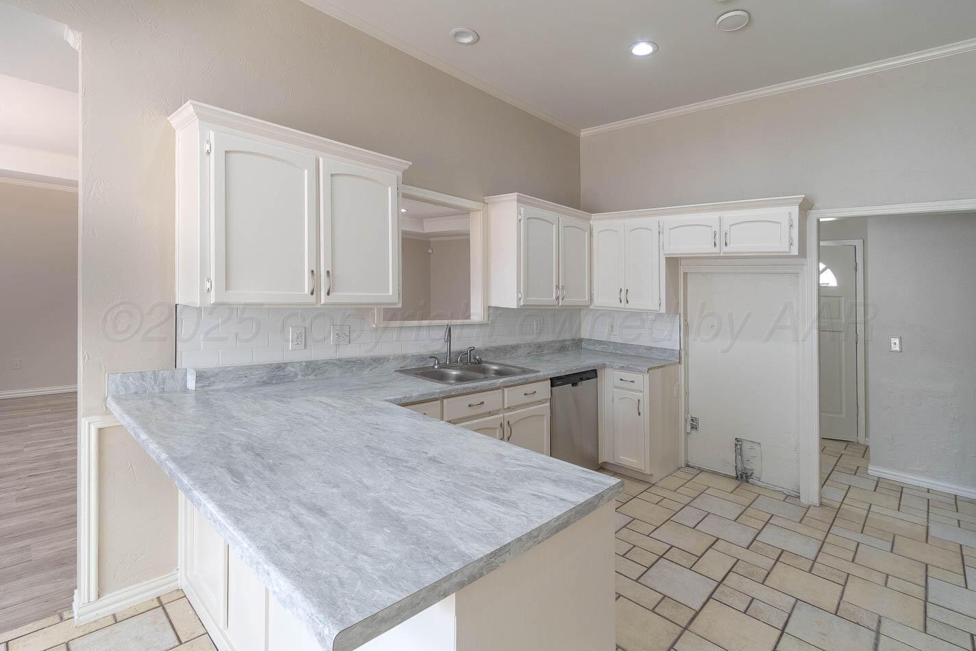 7209 Dukes Place Amarillo, TX 79109 - Photo 8 of 20 a kitchen with a sink refrigerator and cabinets
