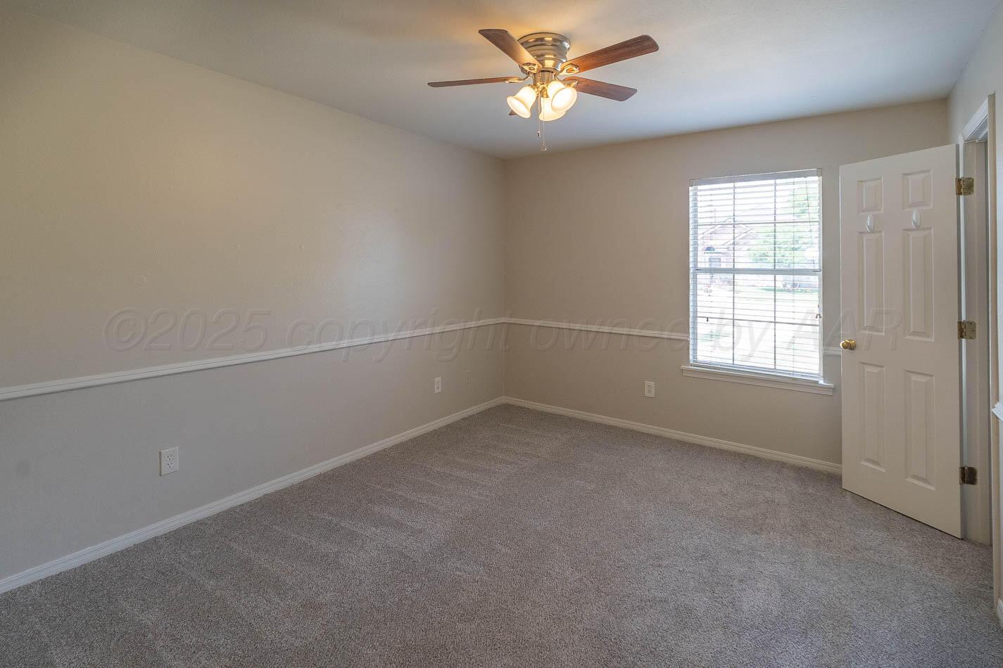 7209 Dukes Place Amarillo, TX 79109 - Photo 9 of 20 an empty room with a window and a fan