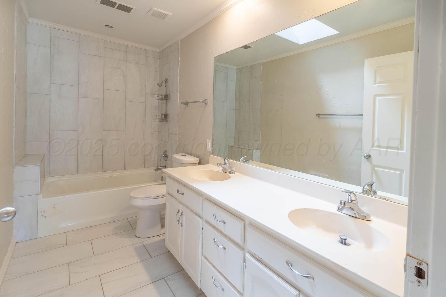 7209 Dukes Place Amarillo, TX 79109 - Photo 10 of 20 a bathroom with a sink a toilet and shower