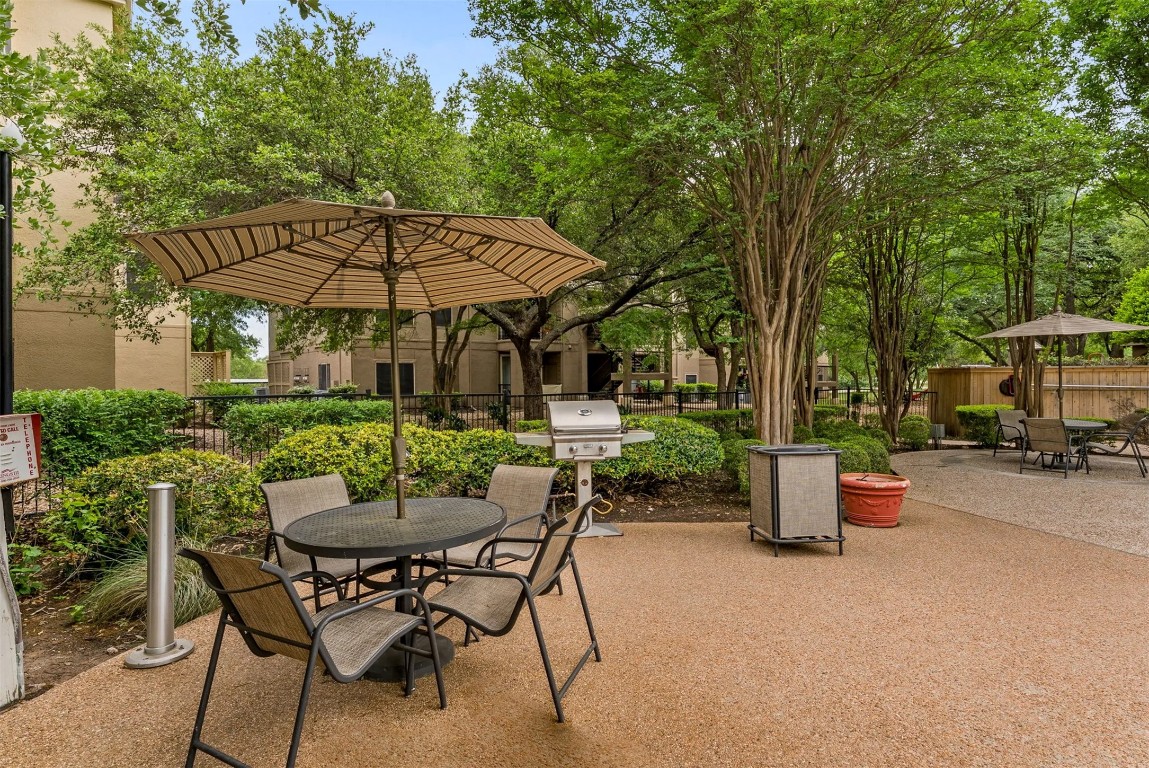 3401 West Parmer Lane, Unit 725 Austin, TX 78727 - Photo 15 of 16 a view of a patio with table and chairs under an umbrella