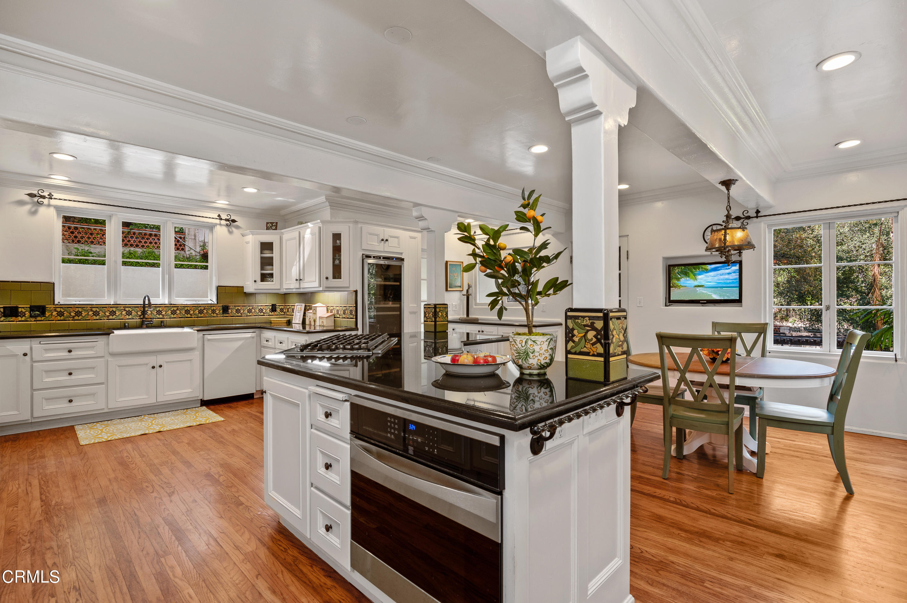 1422 East Palm Street Altadena, CA 91001 - Photo 18 of 64 a kitchen with stainless steel appliances kitchen island granite countertop a stove a sink dishwasher and white cabinets with wooden floor