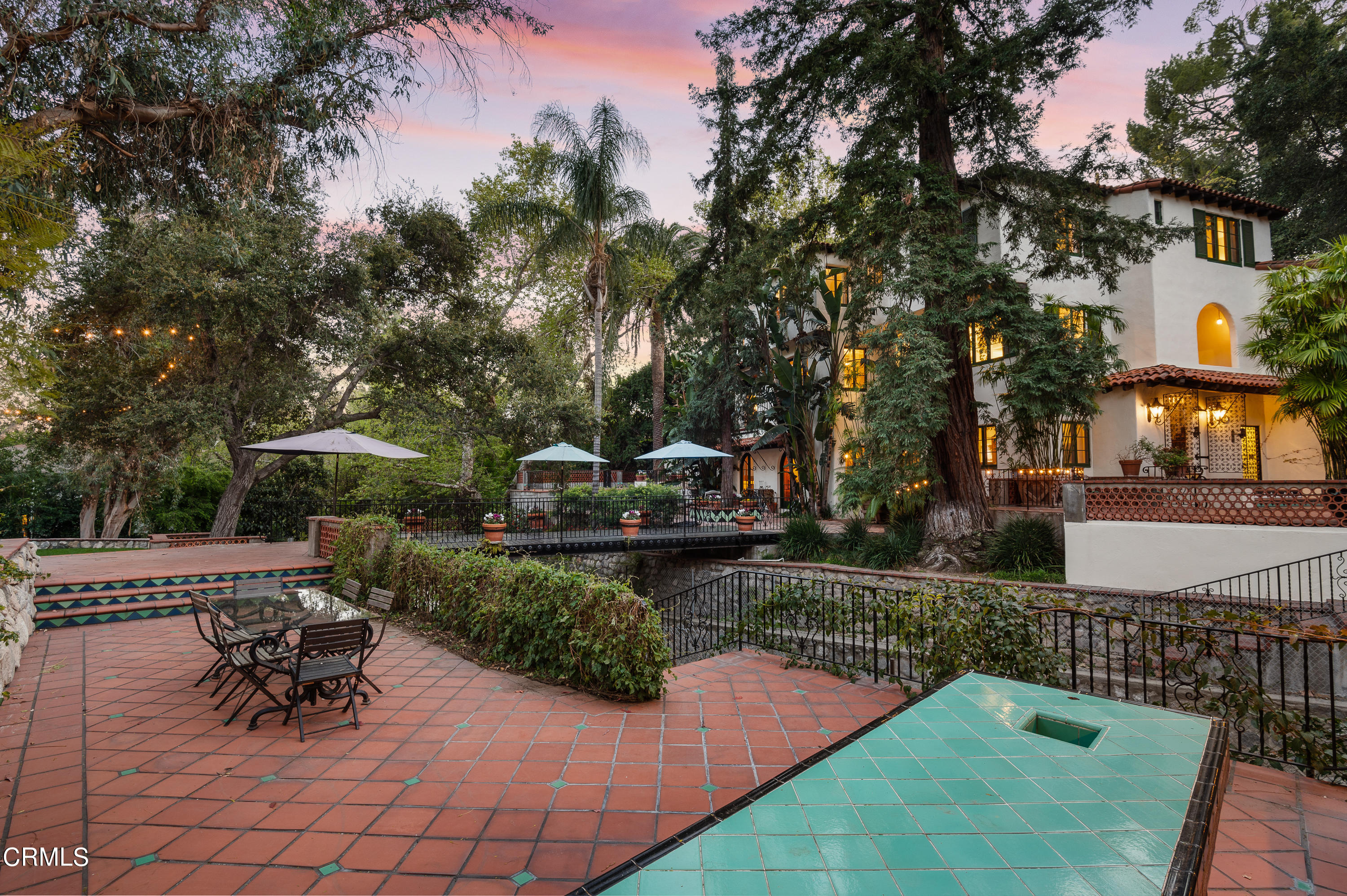 1422 East Palm Street Altadena, CA 91001 - Photo 56 of 64 a view of a patio with table and chairs and potted plants with large tree