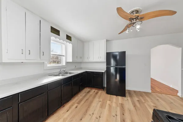 a kitchen with a sink stove and refrigerator