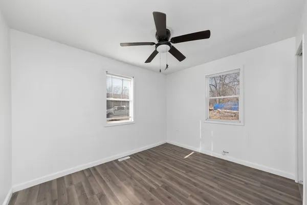 a view of a room with wooden floor and windows