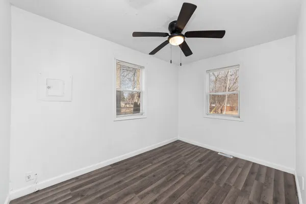 a view of a livingroom with wooden floor and a window