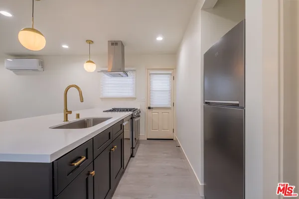 a kitchen with a sink and refrigerator