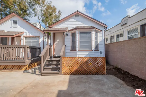 a view of a house with wooden fence