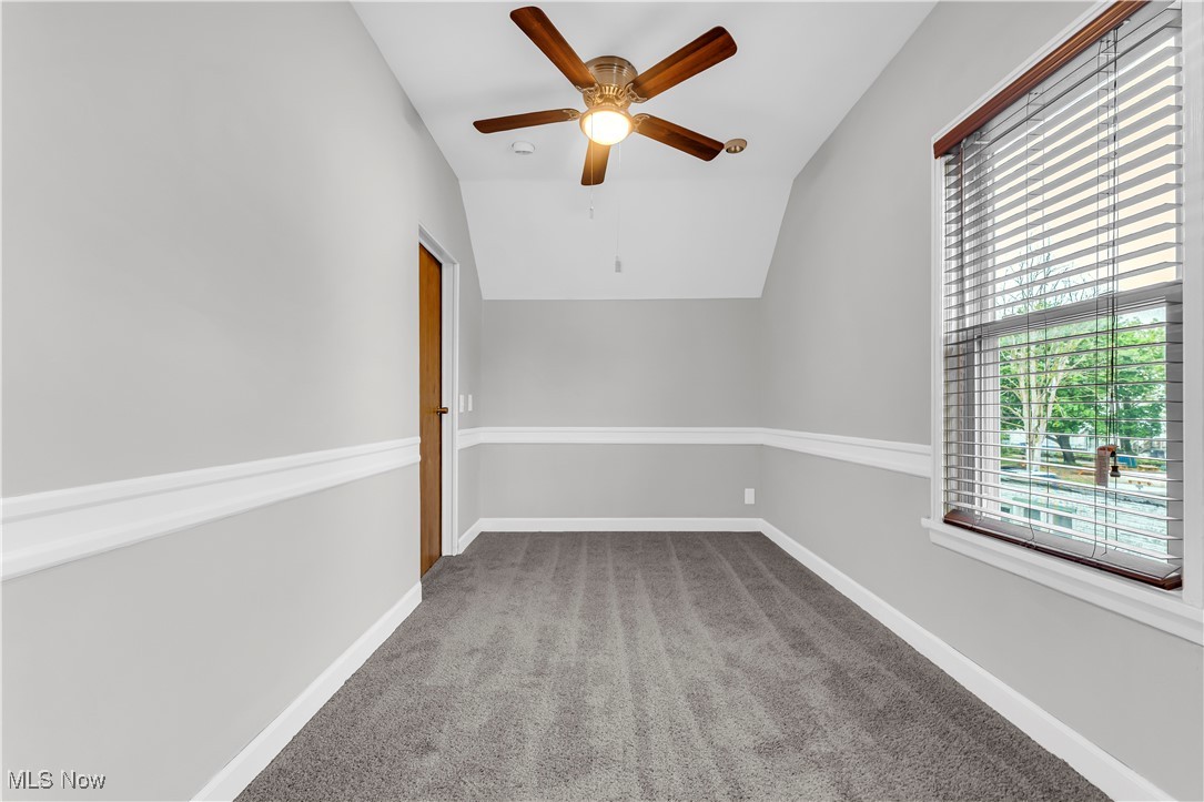 3374 Fulton Road Cleveland, OH 44109 - Photo 19 of 27 Empty room with light colored carpet, vaulted ceiling, and a ceiling fan