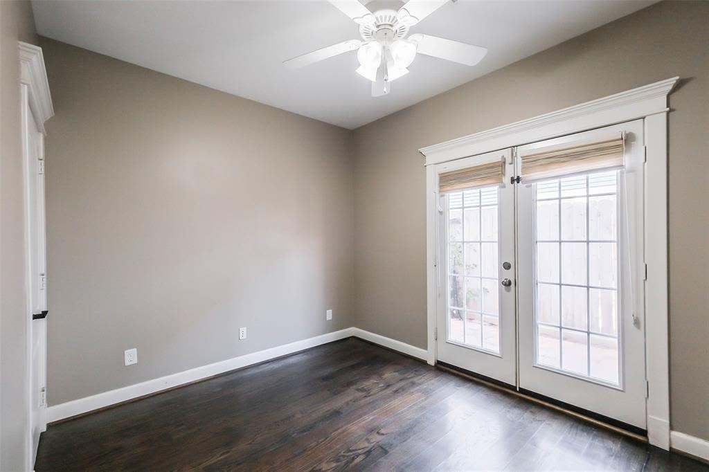 706 Allston Street, Unit B Houston, TX 77007 - Photo 12 of 33 an empty room with wooden floor chandelier fan and windows