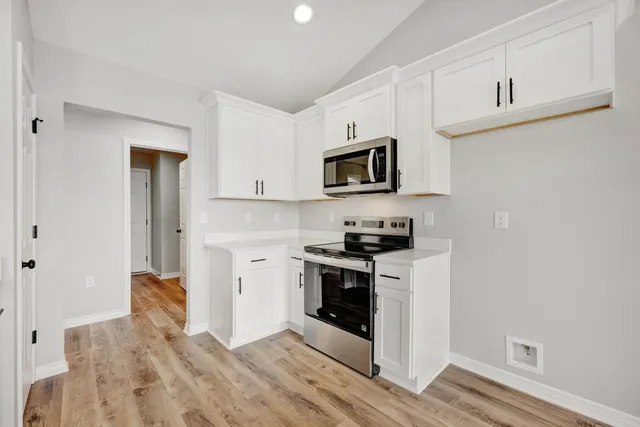 a kitchen with a stove and a microwave