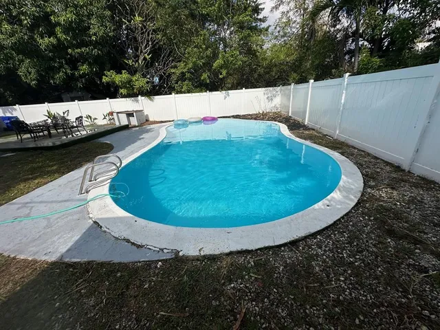 a view of a swimming pool with a yard