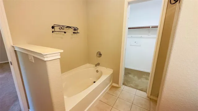 a bathroom with a tub and sink