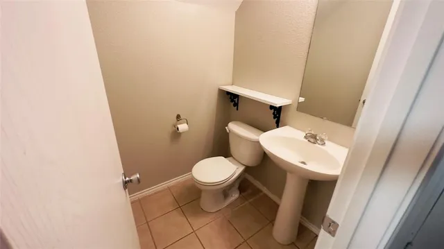 a white toilet sitting next to a white sink