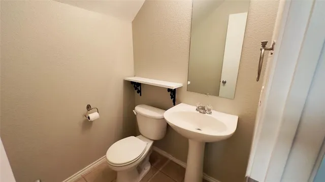 a white toilet sitting next to a bathroom sink