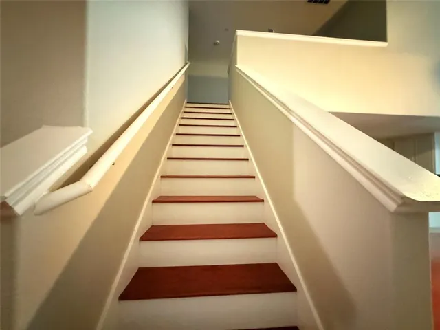 a view of backyard with wooden fence