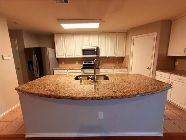 a view of a living room with kitchen island