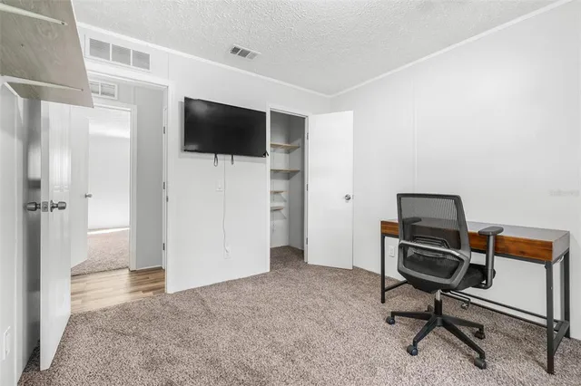 a view of a livingroom with furniture and a flat screen tv