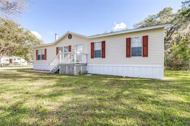 a front view of house with yard and trees