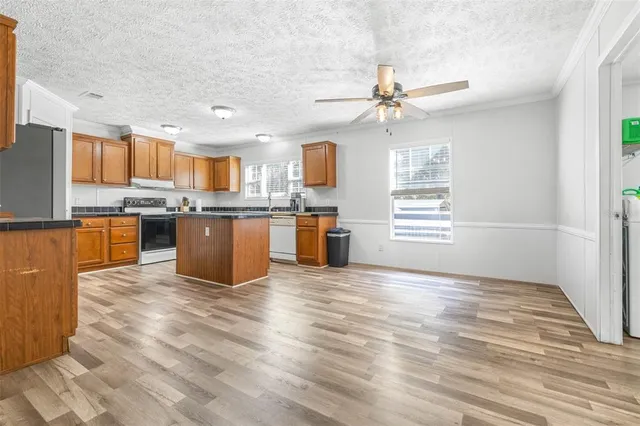 a view of kitchen with wooden floor and window