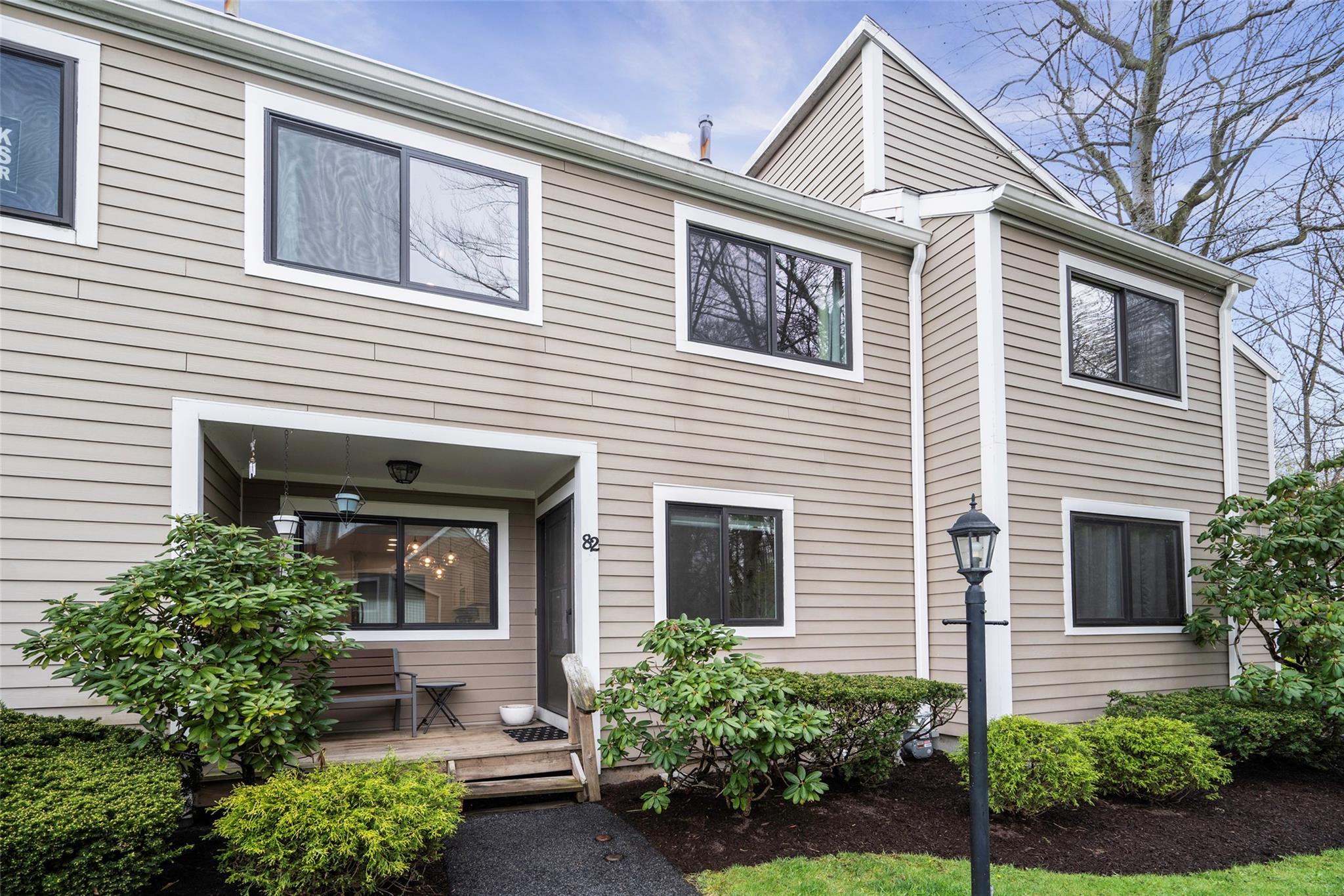 a view of a house with a yard and potted plants