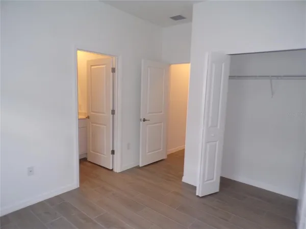 an empty room with wooden floor and a window