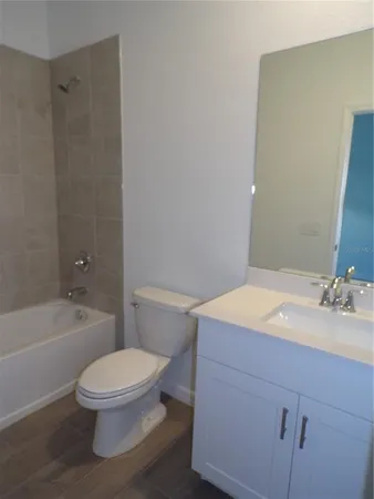 a bathroom with a sink a toilet and a bathtub