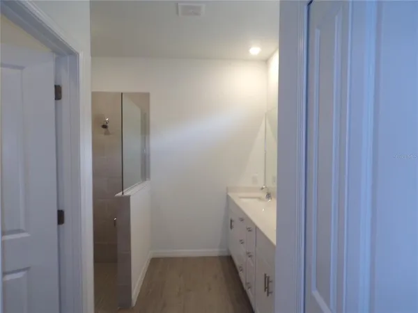 a white toilet sitting next to a white wall