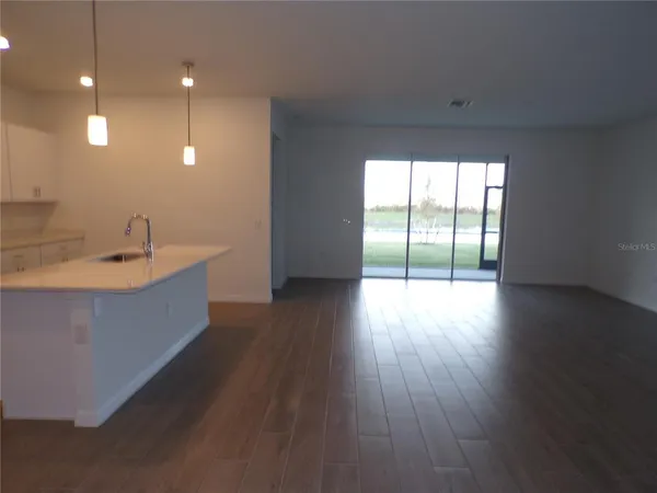 a large room with wooden floor and windows