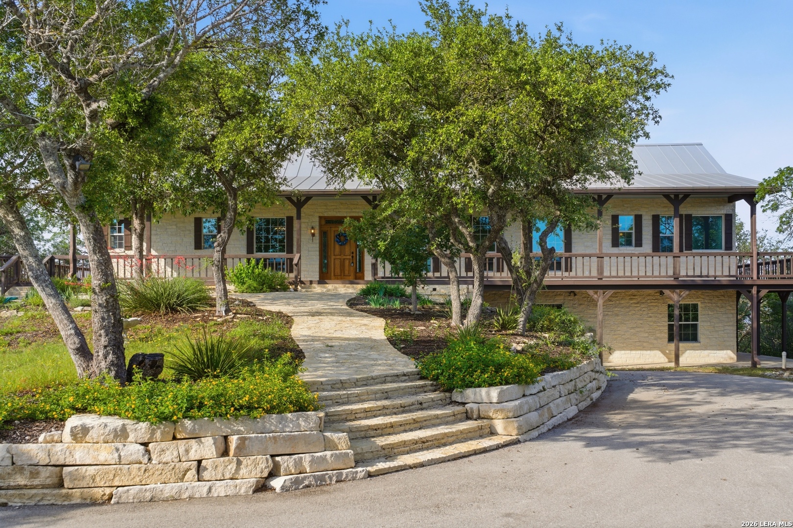 26 Seewald Road Boerne, TX 78006 - Photo 3 of 33 a front view of a house with a garden